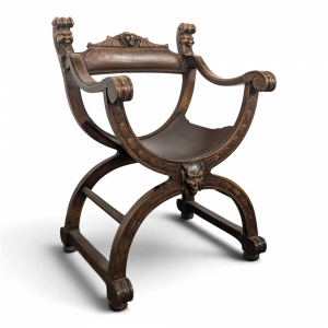 Fauteuil curule Dagobert en noyer sculpté de têtes de lion