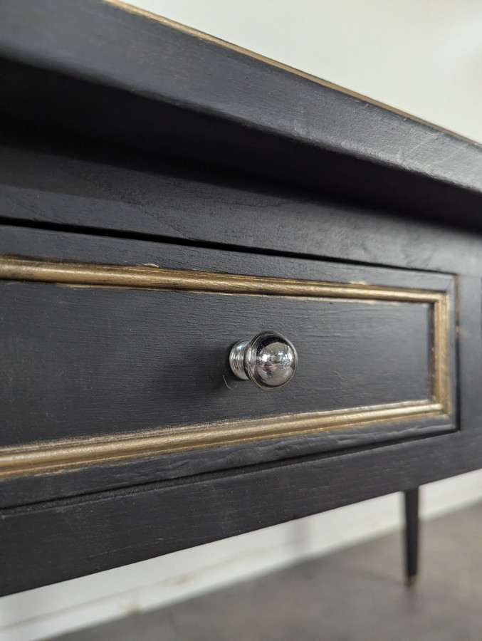 Grand bureau plat de style Louis XVI laqué noir et rechampi or