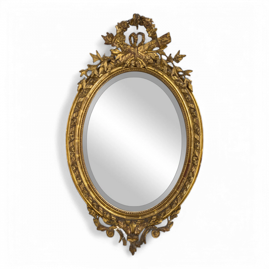 Miroir ovale de style Louis XVI fin XIXe en bois et stuc doré