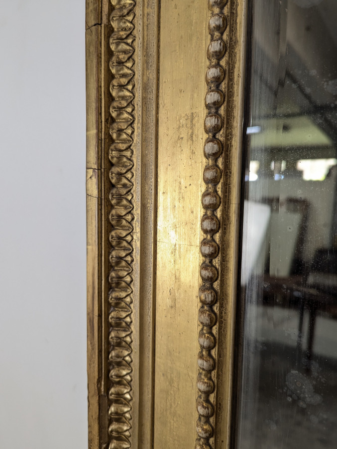 Grand miroir en bois doré de style Louis XVI fin XIXème